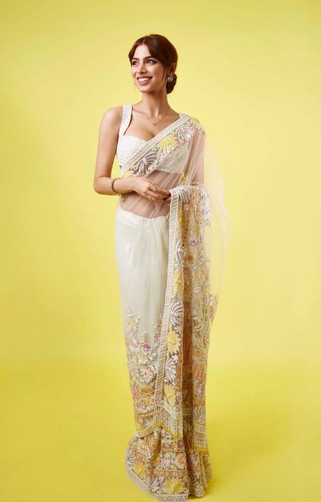 Khushi Kapoor looked elegant in a light yellow floral embroidered sheer saree. She matched the outfit with a dainty gold chain and classic studs
